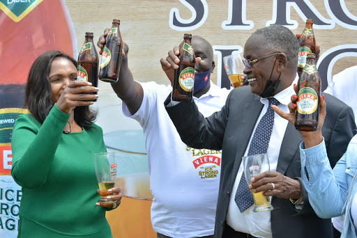 The CEO Keroche Breweries Tabitha Karanja (L) and the Chairman Joseph Karanja (C) join traders in launching Vienna Ice Strong Lager at their Naivasha based factory on 27/4/21. The product that has a ten percent alcohol content is expected to generate Sh1B annually to the exchequer.