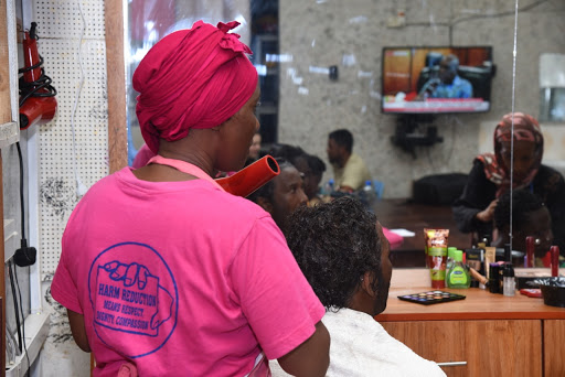 Faiza Jalal, a recovering drug addict, attends to a colleague at the Beauty Corner at Reachout Centre Trust