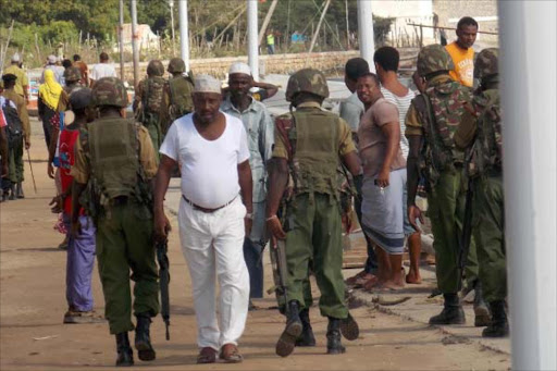 Administration Police officers patrol a street in Lamu town on October 28, 2014. 