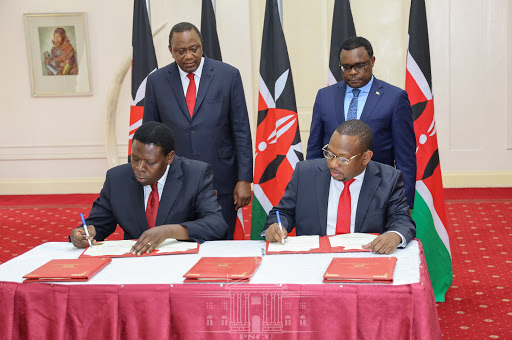 President Uhuru Kenyatta and Senate Speaker Kenneth Lusaka watch as Devolution CS Eugene Wamalwa and Governor Mike Sonko sign agreement transferring Nairobi county functions, State House, February 26, 2020. /PSCU