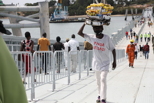 A hawker uses the Liwatoni floating bridge.