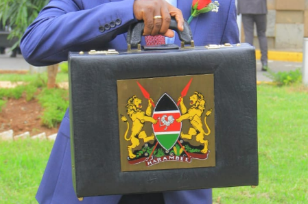 Treasury CS Njuguna Ndungu shows the briefcase containing the 2023-24 Budget proposals ahead of presentation before National Assembly on Thursday, June 15, 2023.