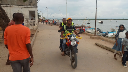 A boda boda operators ferries a passenger in Lamu town.