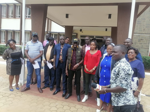 Former Cherangany MP Wesley Korir (in cap) with MCAs-elect at Trans Nzoia HQ presenting application papers to clerk on Saturday. 