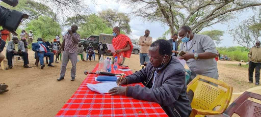 West Pokot Governor John Lonyangapuo signs a peace agreement.