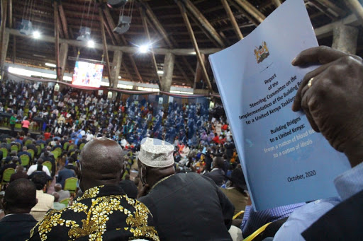 A delegate reads the BBI report during its launch  at Bomas of Kenya on October 26, 2020.