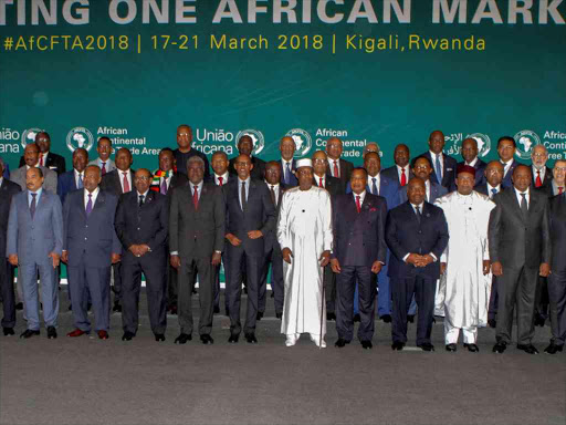 African leaders pose for a group photograph as they meet to sign a free trade deal that would create a liberalized market for goods and services across the continent, in Kigali, Rwanda March 21, 2018. /REUTERS