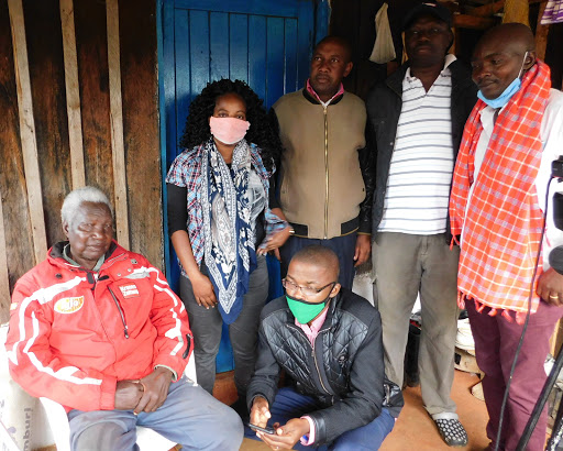 Mau Mau fighter Joseph Mwenda, brigadier to the late Field Marshal Musa Mwariama, with Mwariama's son Joel (in zipped jacket) and relatives