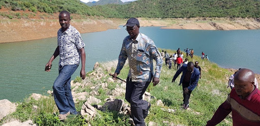 West Pokot Governor John Lonyangapuo and other leaders climbing a highland at Turkwel Dam last year.
e