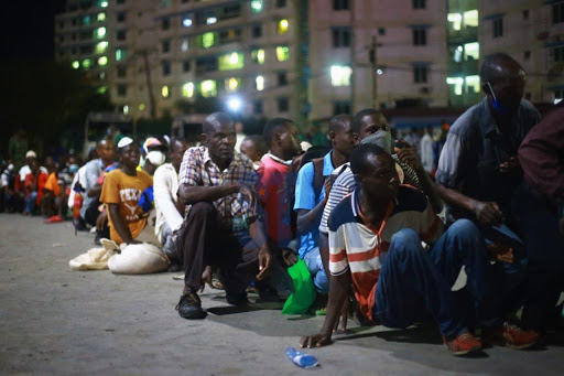 Commutters queue to cross the ferry past 8:30pm on Friday, March 27, 2020.