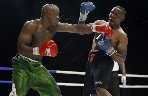 Kenya's Daniel Wanyonyi (R) and Karim Mandongo alias Mtu Kazi (L) of Tanzania in action during their Super MiddleWeight ten round bout at KICC 